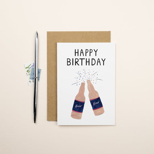 Two brown bottle of beer with confetti